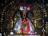 
An extremely ornate statue of Shakyamuni Buddha is the main image inside the main shrine of the Golden Temple in Patan.
